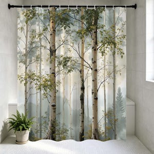 May include: A shower curtain featuring a forest scene with tall birch trees. The trees have white bark with black markings and green leaves. The background shows a misty forest with a soft, muted color palette.