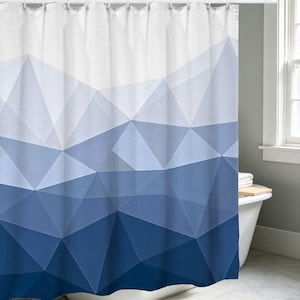 May include: A blue and white geometric patterned shower curtain. The curtain features a gradient design, transitioning from white at the top to various shades of blue at the bottom. The design is composed of angular shapes, creating a modern aesthetic.