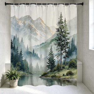 May include: A watercolor shower curtain featuring a mountain landscape with a lake and evergreen trees. The design includes a misty atmosphere with shades of green, blue, and white. The curtain is hanging on a black rod.
