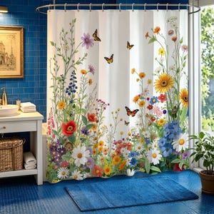 May include: White shower curtain with a colourful floral design, including wildflowers and butterflies. The curtain's bright and cheerful design is ideal for adding a touch of nature to any bathroom. The curtain is hung on a curved shower rod.