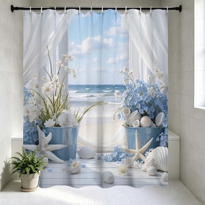 May include: A coastal-themed shower curtain featuring a scenic beach view through a window. The design includes blue buckets with white and blue flowers, seashells, and starfish. The curtain has a white background with a blue sky and ocean view.