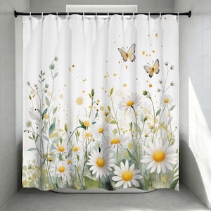 May include: White shower curtain featuring a watercolor design of daisies and butterflies. The curtain has a floral meadow design with yellow and green accents. The butterflies are yellow and the daisies have yellow centers.