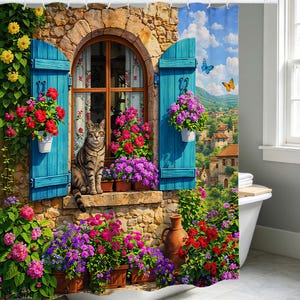 May include: A shower curtain featuring a stone wall with a window, blue shutters, and a tabby cat sitting on the sill. The scene includes vibrant red and purple flowers in pots, climbing yellow vines, butterflies, and a distant village landscape.