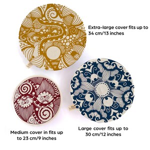 May include: Three round fabric bowl covers with different patterns. The largest cover is yellow and white with a swirling design and fits bowls up to 13 inches in diameter. The medium cover is red and white with a swirling design and fits bowls up to 9 inches in diameter. The smallest cover is blue and white with a floral design and fits bowls up to 12 inches in diameter.