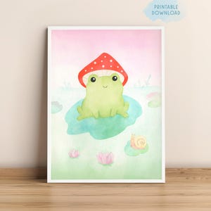 Puede incluir: Una ilustración de acuarela de una rana verde con un sombrero de hongo rojo. La rana está sentada en un nenúfar en un estanque con un caracol cerca. El fondo es de color rosa suave.