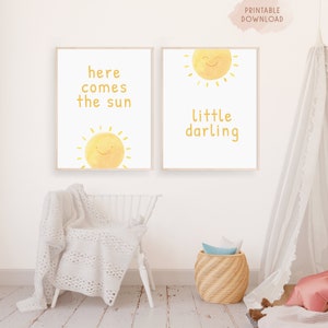 May include: Two printable nursery art prints with a yellow sun and text. The first print says "here comes the sun" and the second print says "little darling".