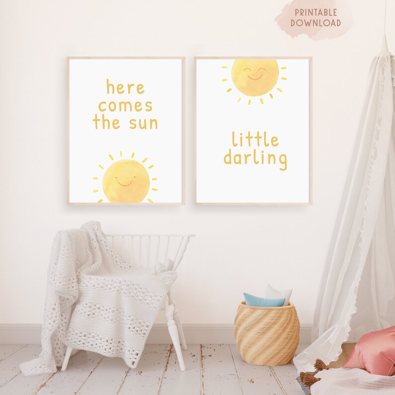 May include: Two printable nursery art prints with a yellow sun and text. The first print says "here comes the sun" and the second print says "little darling".