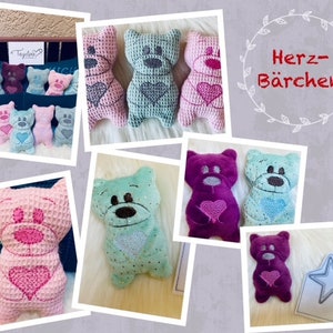 May include: A collection of plush heart-shaped teddy bears in various colors, including pink, blue, purple, and green. The bears have embroidered hearts on their chests and are arranged in a collage with the text "Herz-Bärchen" in a decorative wreath.