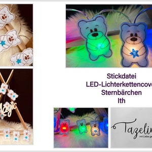May include: White felt teddy bear LED light string with blue star accents. The lights are on and glowing in different colors. The string is hanging on a white fuzzy surface. The text "Stickdatei LED-Lichterkettencover Sternbären lth" is below the lights. The text "Tazeline mit Liebe genäht" is in the bottom right corner.