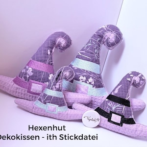 May include: Three plush hats in varying sizes, crafted from purple fabric with a white floral pattern and a waffle-textured brim. Each hat features a pointed, curled top and a decorative band with a square buckle. A round white tag reads Tazeline.