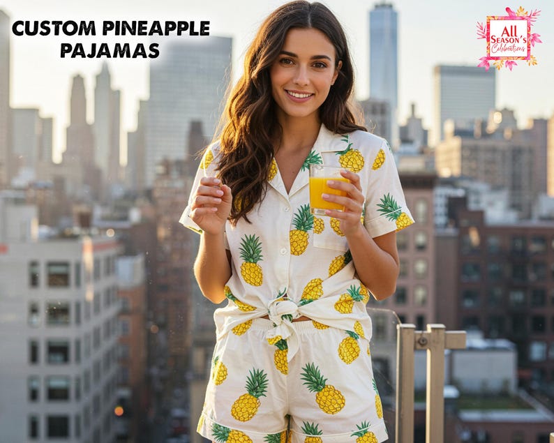 May include: White pajama set with a yellow pineapple pattern. The set includes a short-sleeved, button-down shirt and matching shorts. The text "CUSTOM PINEAPPLE PAJAMAS" is at the top left. The image also includes the text "All Season's Celebrations".