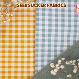 May include: Close-up of seersucker fabrics in yellow and blue-green gingham patterns. The text "SEERSUCKER FABRICS" is at the top. The fabrics are decorated with small white flowers. The logo "All Season's Celebrations" is in the top right corner.