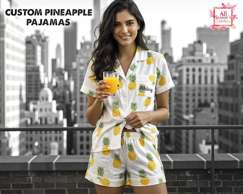 May include: White pajama set with a yellow pineapple pattern. The short-sleeved shirt and shorts are personalized with the name "Ashley". The image also includes the text "CUSTOM PINEAPPLE PAJAMAS".