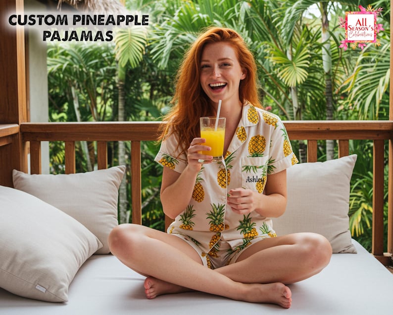 May include: Cream-colored pineapple pajamas with a matching short-sleeved top and shorts. The pajamas feature a repeating pattern of yellow pineapples and green leaves. The text "Custom Pineapple Pajamas" is at the top left.