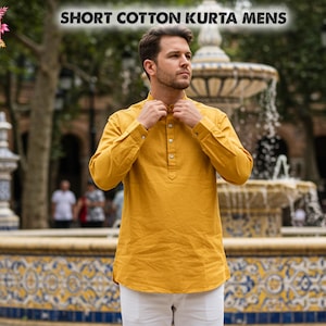 May include: Mustard yellow short cotton kurta with long sleeves and a button-down front. The kurta is paired with white pants. The image includes the text "SHORT COTTON KURTA MENS".
