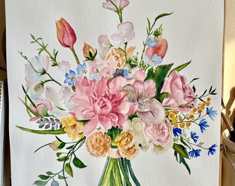 May include: A watercolor painting on white paper depicting a floral bouquet. The arrangement features a large central pink dahlia, surrounded by pink roses, orange tulips, yellow blossoms, and small blue cornflowers, accented with green foliage.