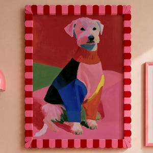 May include: A colorful dog portrait in a pink and red frame hangs above a bed with pink pillows and a yellow striped pillow. A pink wall lamp and a framed Matisse print complete the decor.