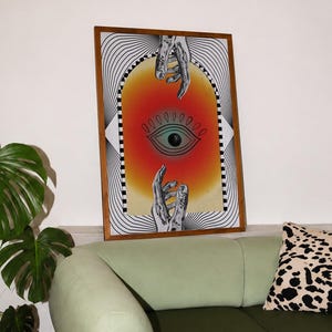 All seeing eye poster featuring a surreal central eye, chrome hands, black-and-white optical lines and a fiery orange gradient in a psychedelic collage style. Display this trippy art print in a living room, bedroom, studio, dorm or eclectic gallery wall to create a bold focal point with graphic movement and retro energy. Designed for collectors of surrealism, optical art and unconventional interiors who enjoy mysterious symbolism, vivid color and artwork that immediately starts a conversation.