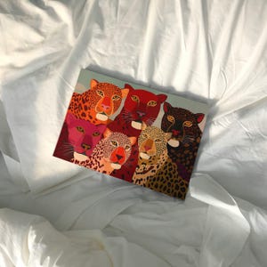 A vibrant maximalist illustration featuring a group of stylized leopards and panthers in bold red, orange, pink, and black tones. The artwork highlights expressive eyes, graphic patterns, and rich color contrasts, creating a striking statement piece inspired by modern folk art, dopamine decor, and eclectic interiors.Leopard Wall Art, Trendy Art Print, Big Cat Poster, Colorful Animal Art, Maximalist Decor, Wild Cat Design, Eclectic Home Art, Modern Folk Style, Red Aesthetic Poster, Dopamine Decor