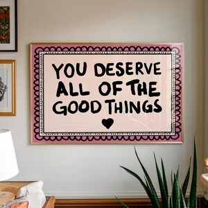 A heartwarming affirmation poster featuring the phrase You Deserve All Of The Good Things in hand-lettered black text with a pink and cream border. Perfect for self-love decor, home offices, or as a thoughtful gift. This piece adds positivity, encouragement, and warmth to any wall.You Deserve Poster, Self Love Wall Art, Positive Quote Print, Motivational Home Art, Pink Modern Poster, Inspirational Typography, Empowering Print, Daily Affirmation Art, Encouraging Quote, Feminine Room Print