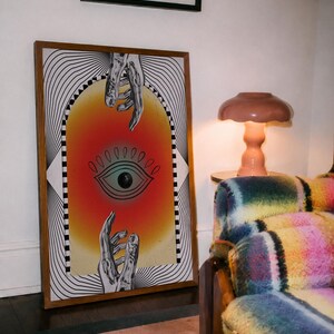 All seeing eye poster featuring a surreal central eye, chrome hands, black-and-white optical lines and a fiery orange gradient in a psychedelic collage style. Display this trippy art print in a living room, bedroom, studio, dorm or eclectic gallery wall to create a bold focal point with graphic movement and retro energy. Designed for collectors of surrealism, optical art and unconventional interiors who enjoy mysterious symbolism, vivid color and artwork that immediately starts a conversation.