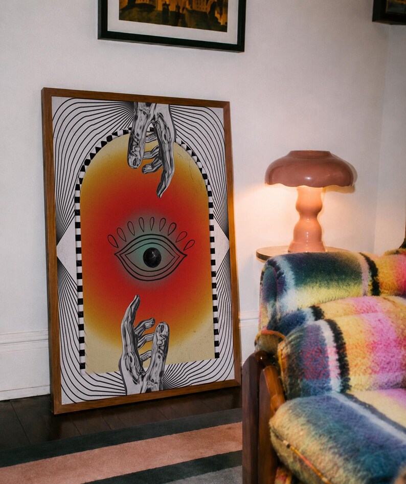 All seeing eye poster featuring a surreal central eye, chrome hands, black-and-white optical lines and a fiery orange gradient in a psychedelic collage style. Display this trippy art print in a living room, bedroom, studio, dorm or eclectic gallery wall to create a bold focal point with graphic movement and retro energy. Designed for collectors of surrealism, optical art and unconventional interiors who enjoy mysterious symbolism, vivid color and artwork that immediately starts a conversation.