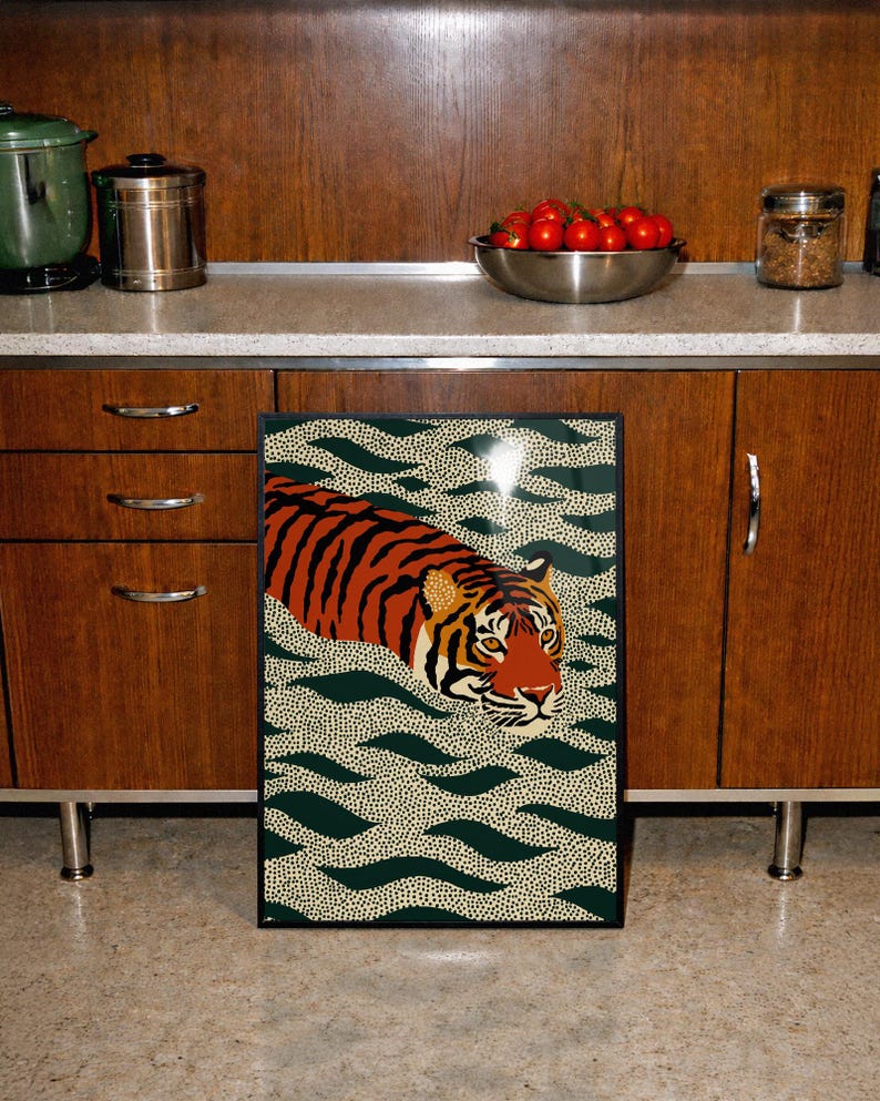 Stylized tiger illustration moving through abstract green wave patterns with dotted textures on a neutral background. The bold orange and black striped tiger contrasts with the rhythmic organic shapes, creating a dynamic maximalist composition. Hand drawn details and modern folk art influences give the artwork a playful yet powerful visual identity. Perfect for living room wall decor, kids room styling, eclectic interiors, or jungle themed spaces seeking a bold statement animal artwork.