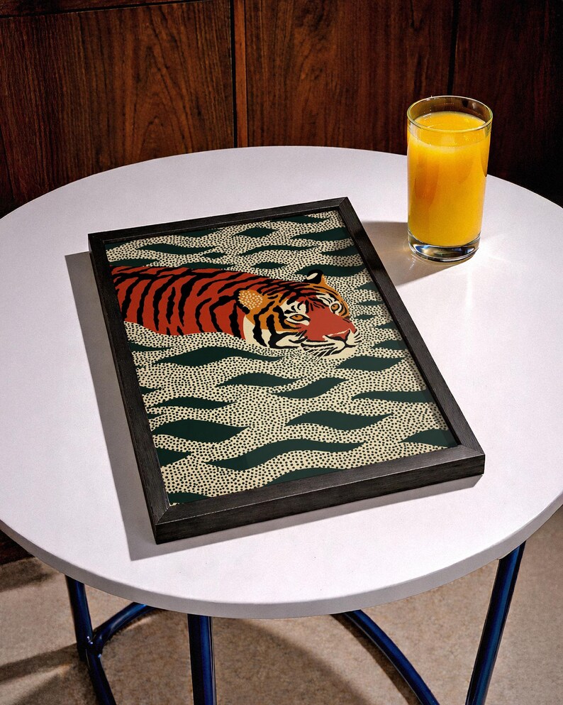 Stylized tiger illustration moving through abstract green wave patterns with dotted textures on a neutral background. The bold orange and black striped tiger contrasts with the rhythmic organic shapes, creating a dynamic maximalist composition. Hand drawn details and modern folk art influences give the artwork a playful yet powerful visual identity. Perfect for living room wall decor, kids room styling, eclectic interiors, or jungle themed spaces seeking a bold statement animal artwork.