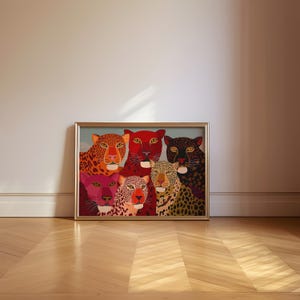 A vibrant maximalist illustration featuring a group of stylized leopards and panthers in bold red, orange, pink, and black tones. The artwork highlights expressive eyes, graphic patterns, and rich color contrasts, creating a striking statement piece inspired by modern folk art, dopamine decor, and eclectic interiors.Leopard Wall Art, Trendy Art Print, Big Cat Poster, Colorful Animal Art, Maximalist Decor, Wild Cat Design, Eclectic Home Art, Modern Folk Style, Red Aesthetic Poster, Dopamine Decor
