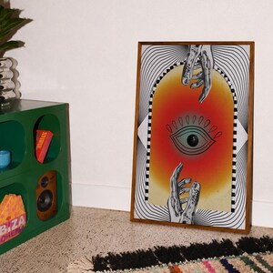 All seeing eye poster featuring a surreal central eye, chrome hands, black-and-white optical lines and a fiery orange gradient in a psychedelic collage style. Display this trippy art print in a living room, bedroom, studio, dorm or eclectic gallery wall to create a bold focal point with graphic movement and retro energy. Designed for collectors of surrealism, optical art and unconventional interiors who enjoy mysterious symbolism, vivid color and artwork that immediately starts a conversation.