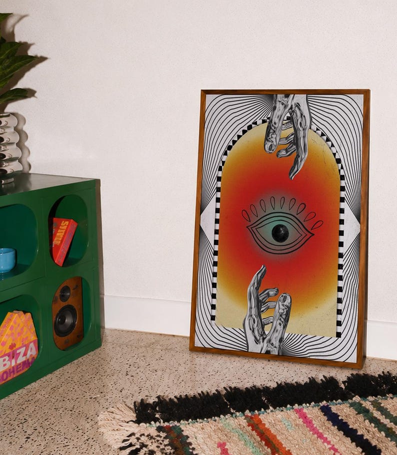 All seeing eye poster featuring a surreal central eye, chrome hands, black-and-white optical lines and a fiery orange gradient in a psychedelic collage style. Display this trippy art print in a living room, bedroom, studio, dorm or eclectic gallery wall to create a bold focal point with graphic movement and retro energy. Designed for collectors of surrealism, optical art and unconventional interiors who enjoy mysterious symbolism, vivid color and artwork that immediately starts a conversation.