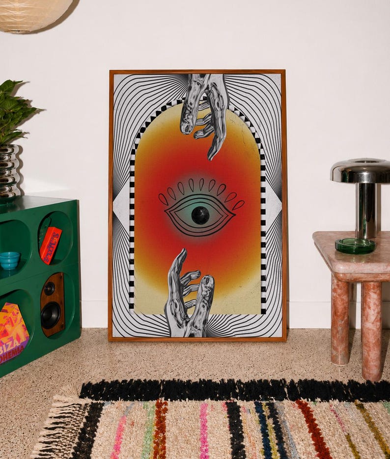 All seeing eye poster featuring a surreal central eye, chrome hands, black-and-white optical lines and a fiery orange gradient in a psychedelic collage style. Display this trippy art print in a living room, bedroom, studio, dorm or eclectic gallery wall to create a bold focal point with graphic movement and retro energy. Designed for collectors of surrealism, optical art and unconventional interiors who enjoy mysterious symbolism, vivid color and artwork that immediately starts a conversation.