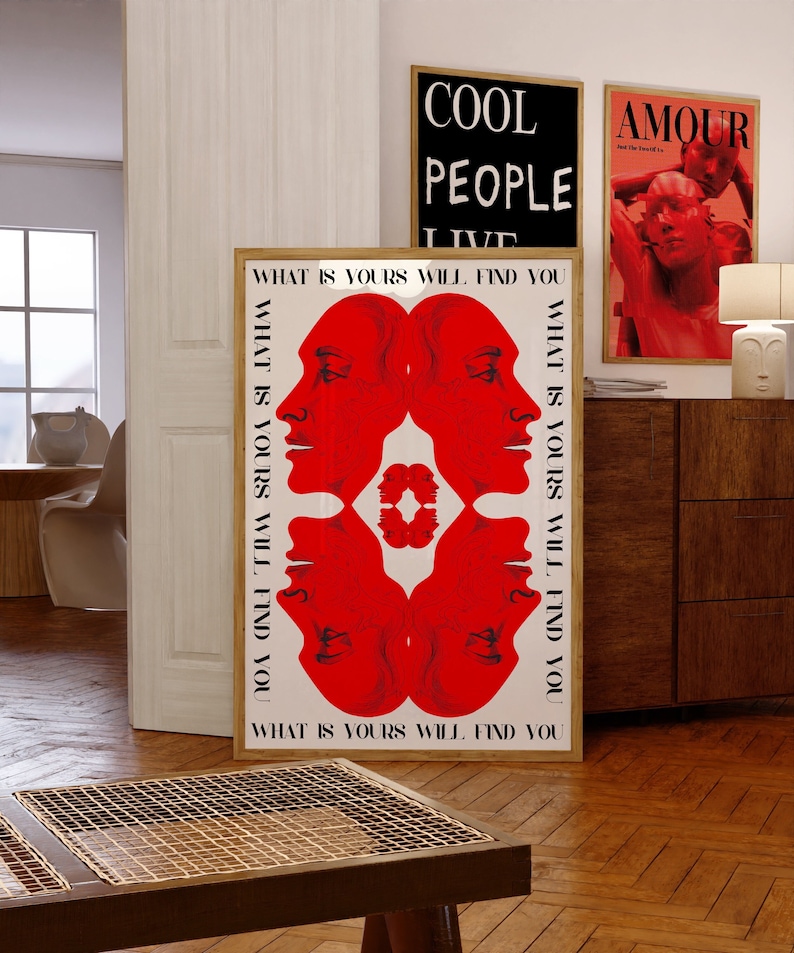 May include: A white poster with a red and white design of four faces. The poster has the text "WHAT IS YOURS WILL FIND YOU" repeated four times.