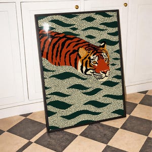 Stylized tiger illustration moving through abstract green wave patterns with dotted textures on a neutral background. The bold orange and black striped tiger contrasts with the rhythmic organic shapes, creating a dynamic maximalist composition. Hand drawn details and modern folk art influences give the artwork a playful yet powerful visual identity. Perfect for living room wall decor, kids room styling, eclectic interiors, or jungle themed spaces seeking a bold statement animal artwork.