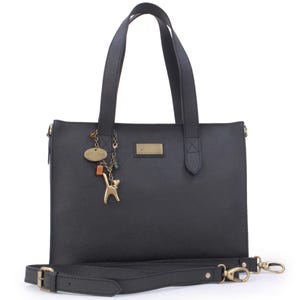 May include: Black tote bag with a detachable shoulder strap. The bag has a gold-coloured cat charm and a small rectangular gold-coloured tag. The bag has two handles and a gold-coloured clasp. The text "CAT WALK" is on the charm.