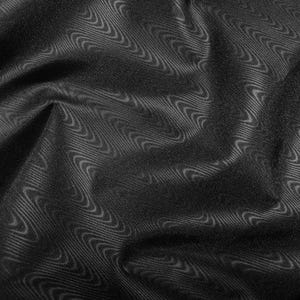 May include: Black fabric with a wavy, textured pattern. The fabric is draped and folded, creating a soft, flowing look.