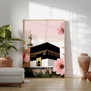 May include: A watercolor painting of the Kaaba in Mecca, Saudi Arabia, with a pink background and pink flowers. The Kaaba is a cube-shaped building that is the holiest site in Islam.