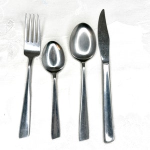 May include: A set of silverware, including a fork, a spoon, and a butter knife, all made of stainless steel.