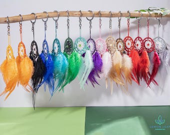 May include: A collection of 14 colorful dreamcatchers with feathers hanging from a metal rod. Each dreamcatcher has a different color and pattern, including blue, green, red, purple, and white.