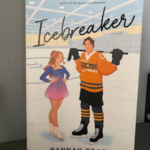 May include: A book cover for "Icebreaker" by Hannah Grace. The cover features illustrations of a woman in a figure skating dress and a man in a hockey jersey. The title is in large, cursive letters. The cover also includes a quote and the author's name.