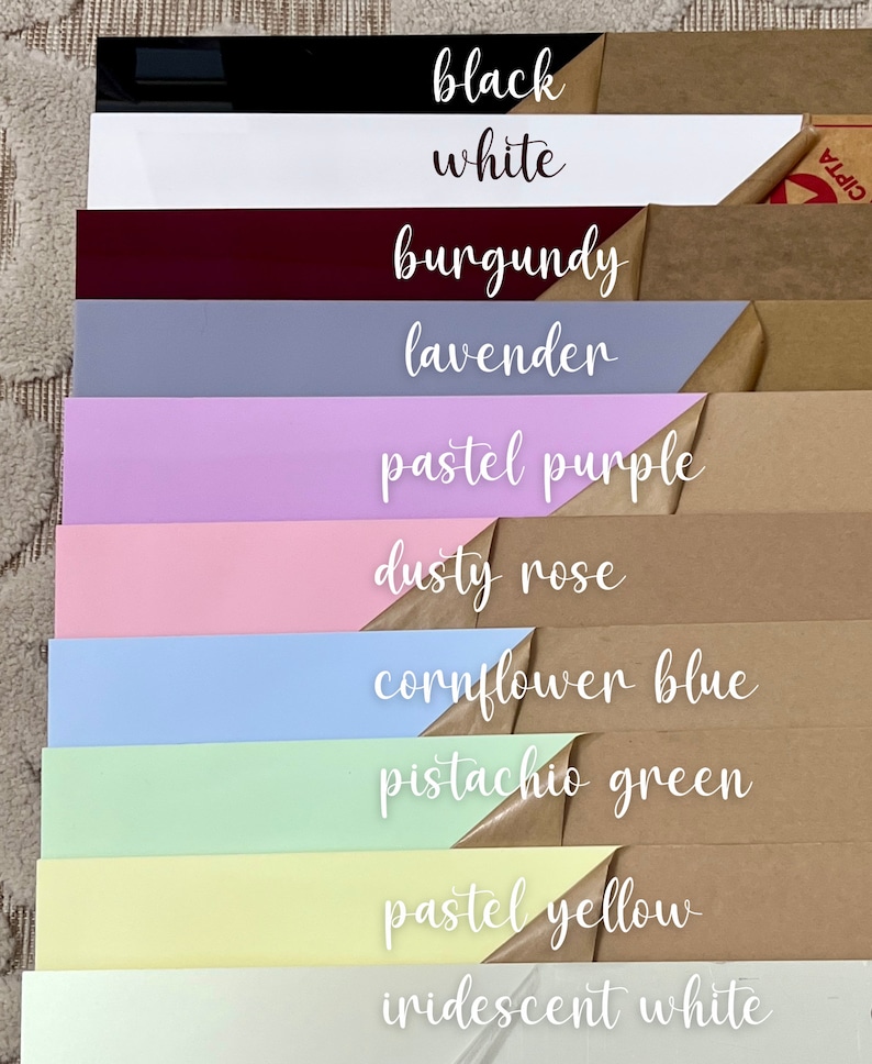 May include: A stack of colorful acrylic sheets with handwritten labels. Colors include black, white, burgundy, lavender, pastel purple, dusty rose, cornflower blue, pistachio green, pastel yellow, and iridescent white.