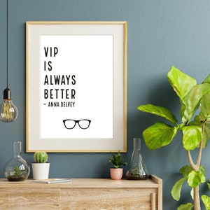 May include: A framed print with a white background and black text that reads "VIP is always better - Anna Delvey".  A pair of black eyeglasses are below the text.
