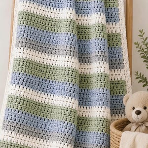 Op de afbeelding: Een gehaakte babydeken met horizontale strepen in wit, saliegroen, lichtblauw en grijs. De tekst Simple Stripes Baby Blanket — CROCHET PATTERN — staat bovenaan gedrukt. De deken heeft een gestructureerd steekpatroon en een witte rand.