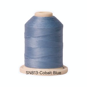 May include: A spool of blue thread with the text "SN813-Cobalt Blue" on the label.