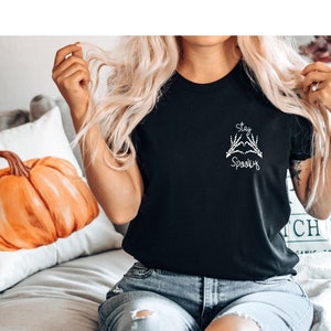 May include: Black t-shirt with a white graphic of two skeleton hands making a heart shape with the text "Stay Spooky".