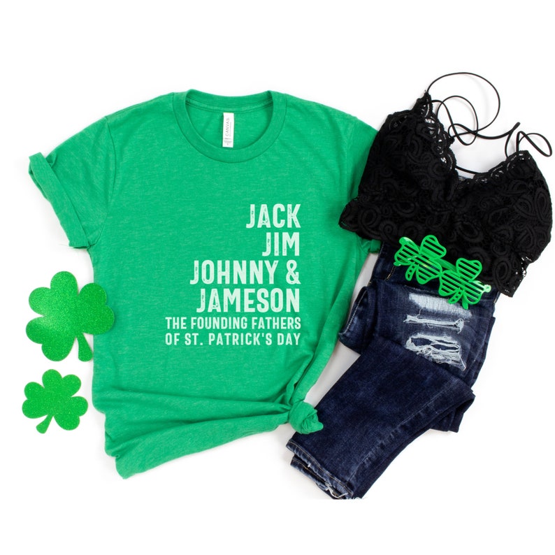 May include: Green t-shirt with white text that reads "Jack Jim Johnny & Jameson The Founding Fathers of St. Patrick's Day".