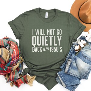 May include: A green t-shirt with the text "I will not go quietly back to the 1950's" printed on it.