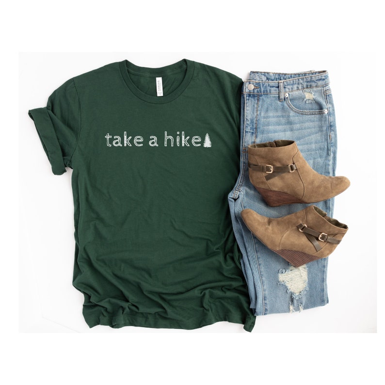 May include: A dark green t-shirt with the text "take a hike" and a small white pine tree graphic.