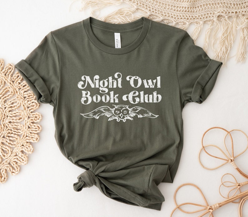 May include: A green t-shirt with the text "Night Owl Book Club" in white with a vintage owl graphic.