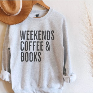 May include: A grey sweatshirt with the text "Weekends Coffee & Books" printed in black.